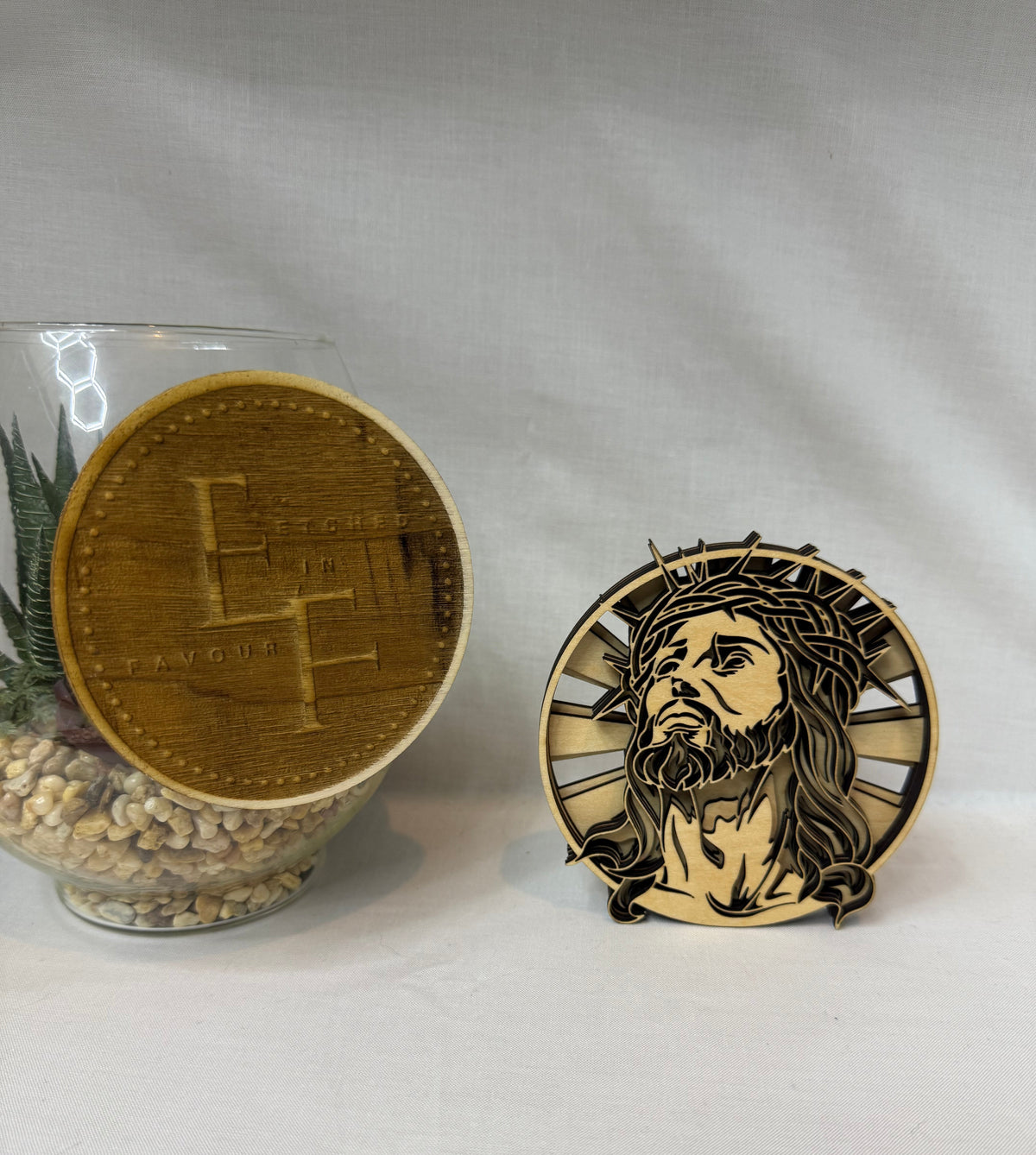 Laser cut multilayer wood decor piece of Jesus wearing the crown of thorns with sun rays in the background from Etched in Favour.  