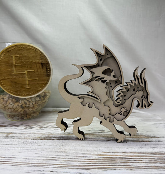 A laser cut multilayer wooden dragon decor piece featuring a majestic scene within the silhouette of the dragon from Etched in Favour.  