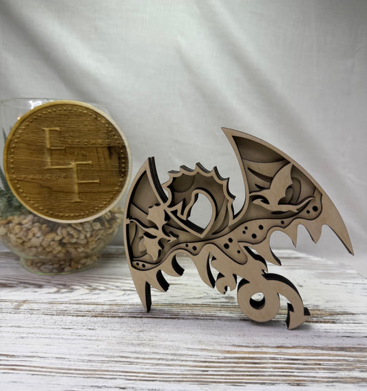A laser cut multilayer wooden dragon decor piece featuring a majestic scene within the silhouette of the dragon from Etched in Favour.
